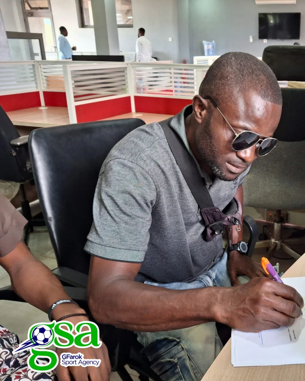 A player signing a representation contract at the GFarok Sports Agency office