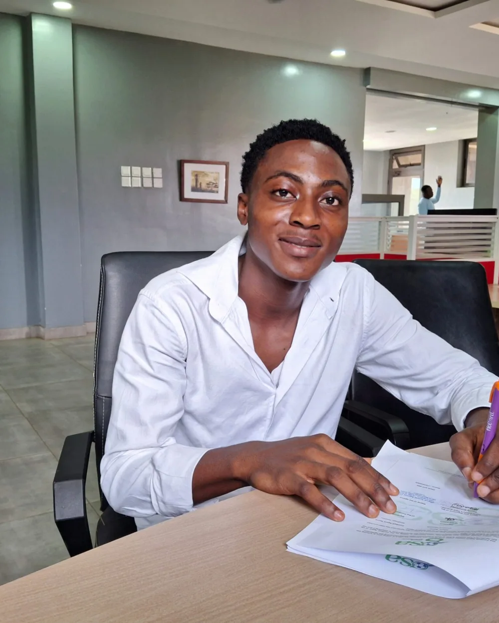 Isaac signing a representation contract at the GFarok Sports Agency office